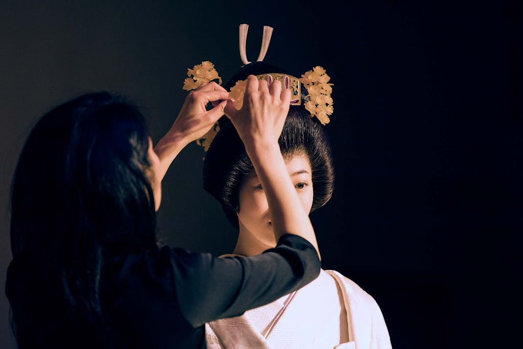 A kimono expert dresses the bride in her traditional Japanese wedding kimono.