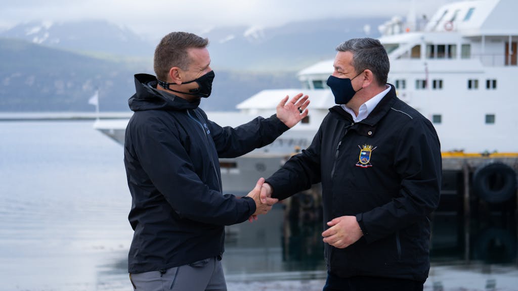 Conrad Combrink and Puerto Williams mayor Patricio Fernández celebrate Silversea's Antarctica return to service